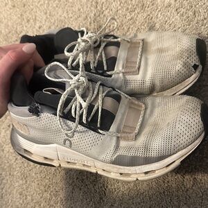 On Running Cream and Black Athletic Shoes